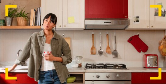 Mujer en cocina organizado con taza en mano.
